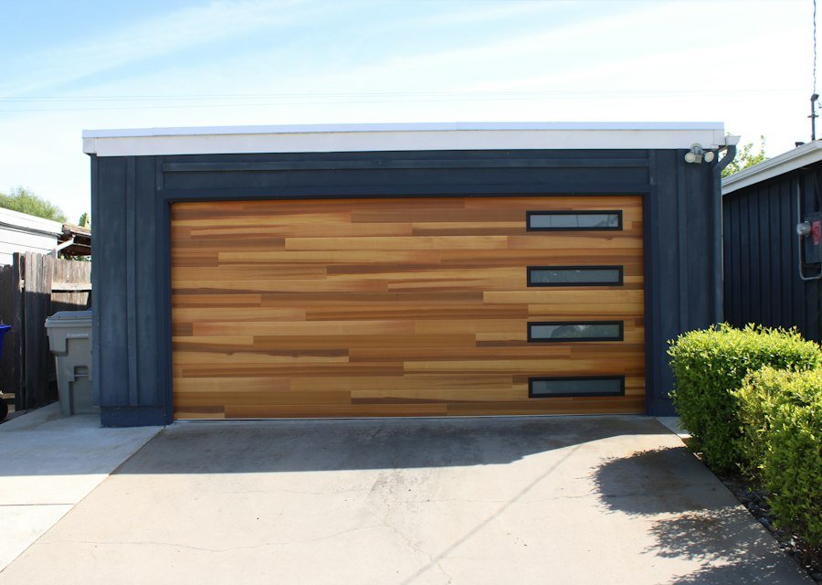 Modern garage door with wood panels and windows