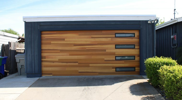 Modern garage door with wood panels and windows